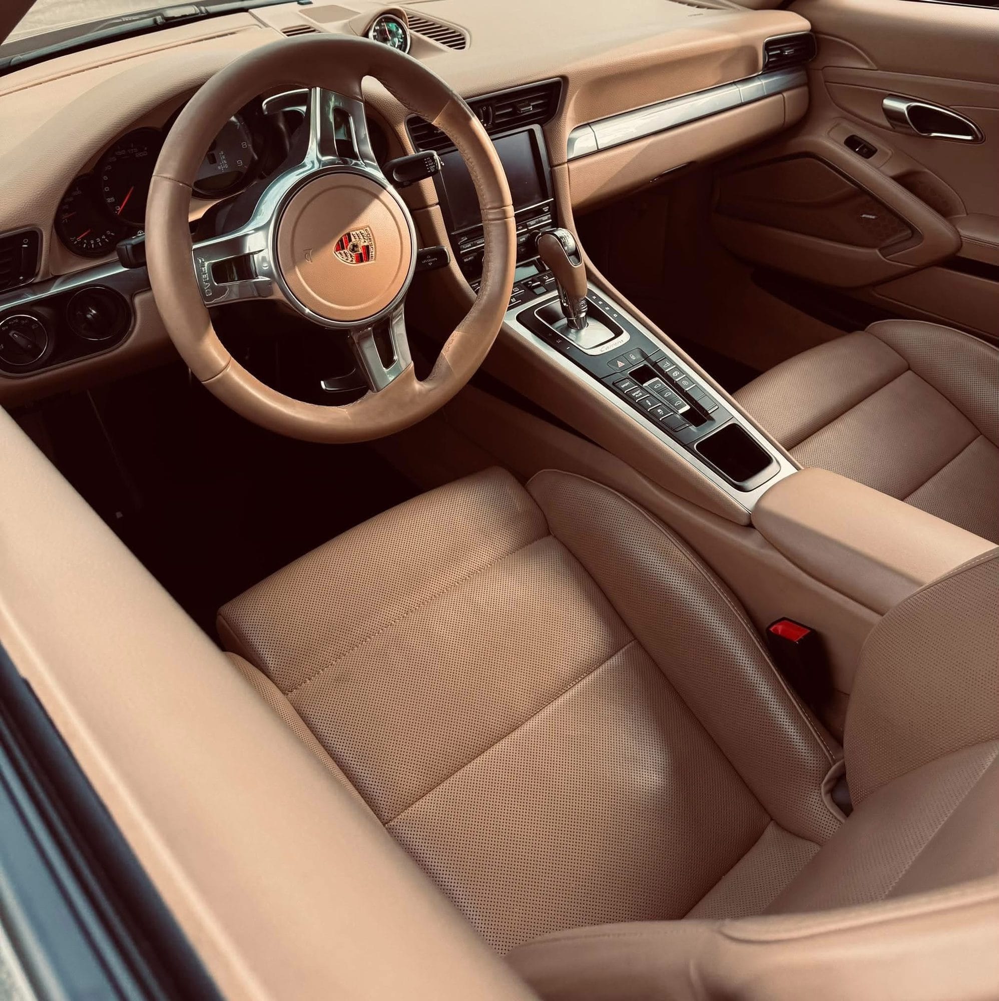 Tan leather Porsche 911 interior after detailing