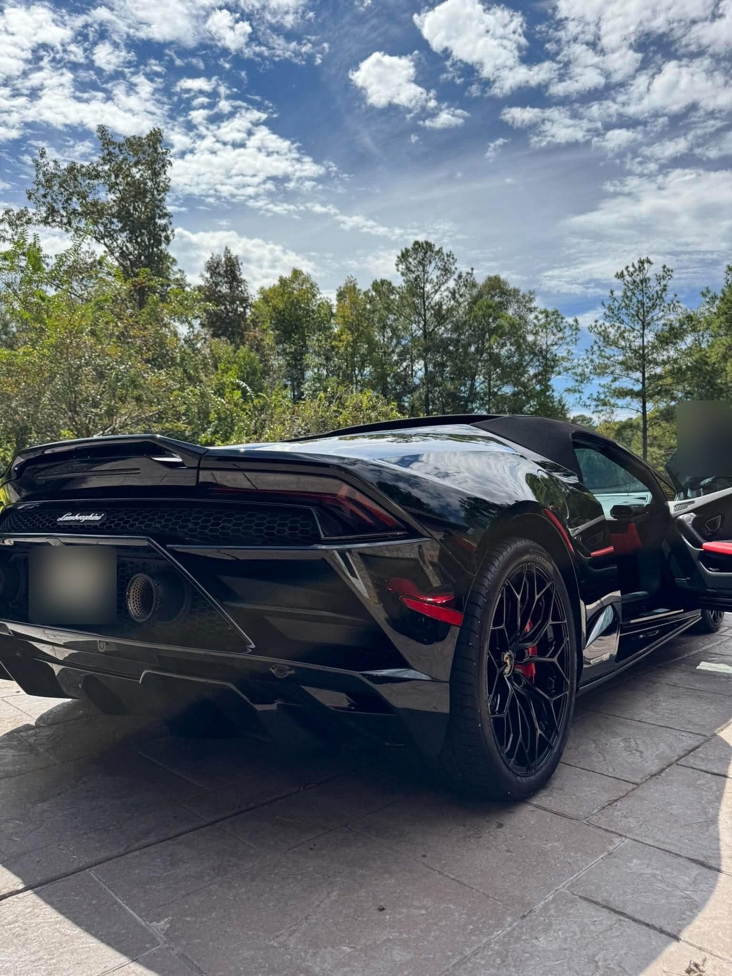 Black Lamborghini Huracán rear three-quarter view after detailing